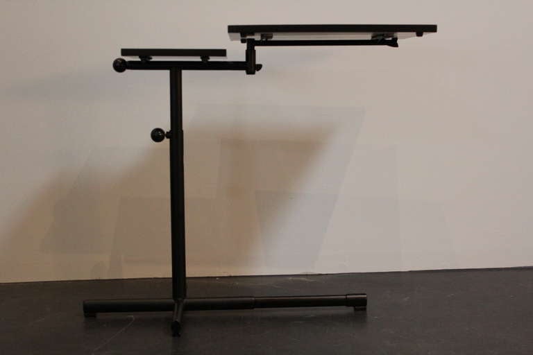 Extremely functional table by Embru-Werke, Switzerland, designed in 1936 by Francois Caruelle. This model with powdercoated black frame and ebonized wood. We have two available.
