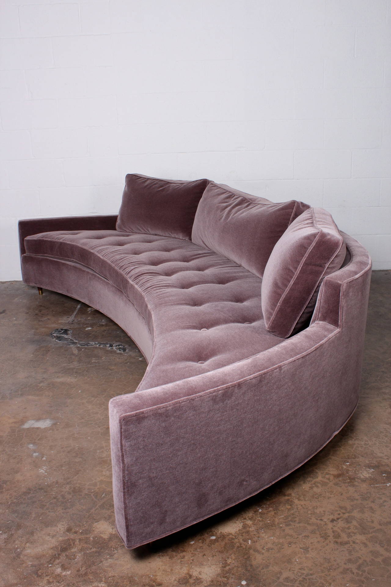 A large curved sofa designed by Harvey Probber reupholstered in mohair. Pair available.