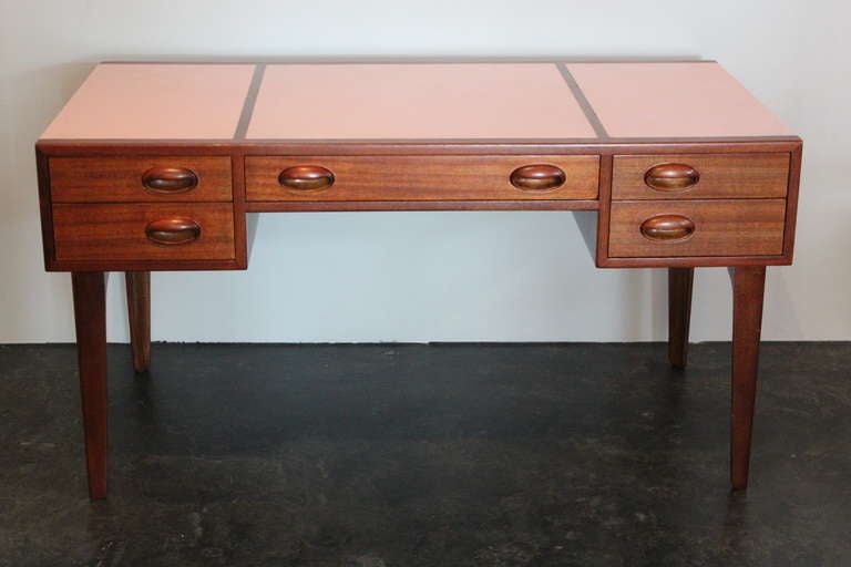 Mahogany partners desk with original pink leather. This early design has drawers on both sides.