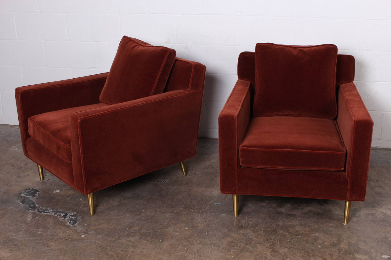 A beautiful pair of brass legged lounge chairs designed by Edward Wormley for Dunbar. Fully restored in a rust mohair with down cushions.