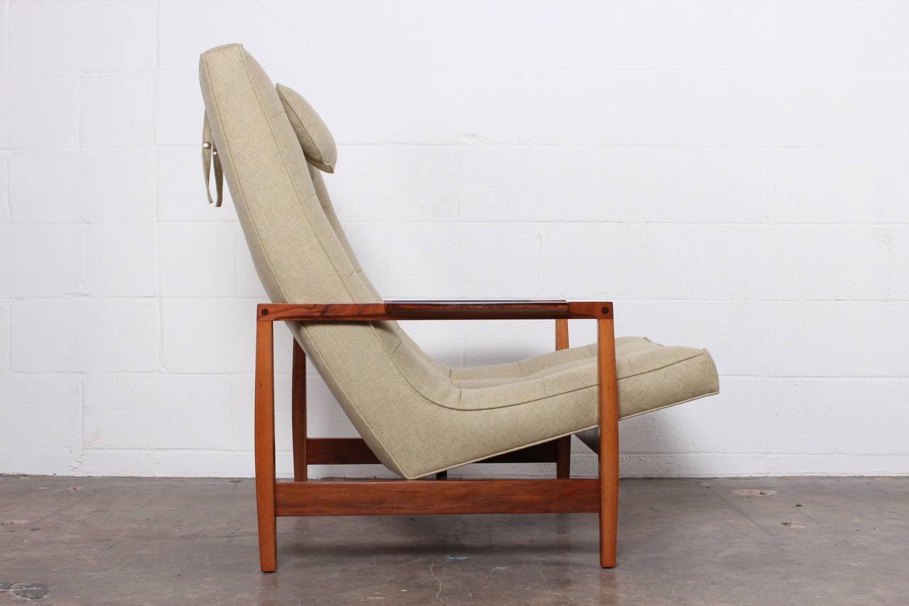 A large-scale lounge chair with walnut and rosewood frame and exposed joinery. Designed by Kipp Stewart for directional.