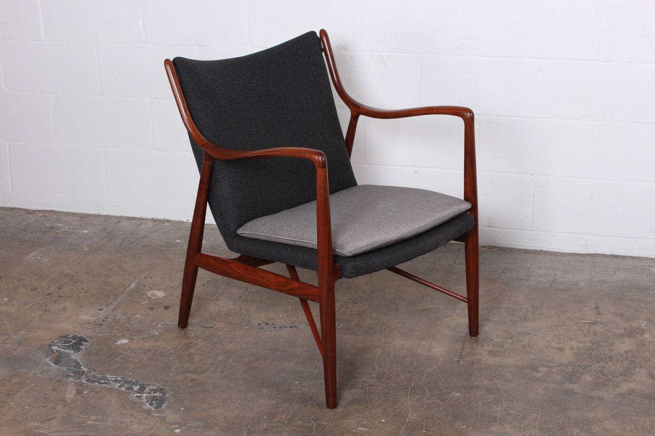 A walnut NV45 lounge chair designed by Finn Juhl for Baker.
