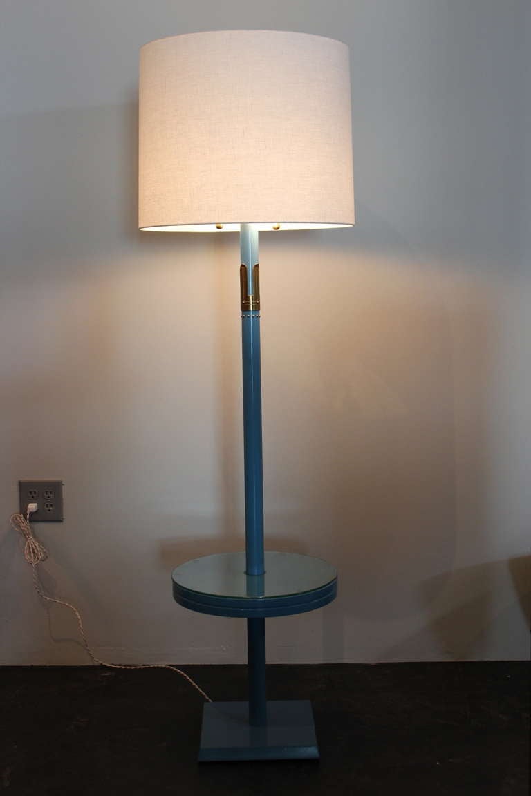 A pair of matching floor lamps with attached tables in original blue lacquer. Designed by Tommi Parzinger for Parzinger Originals.