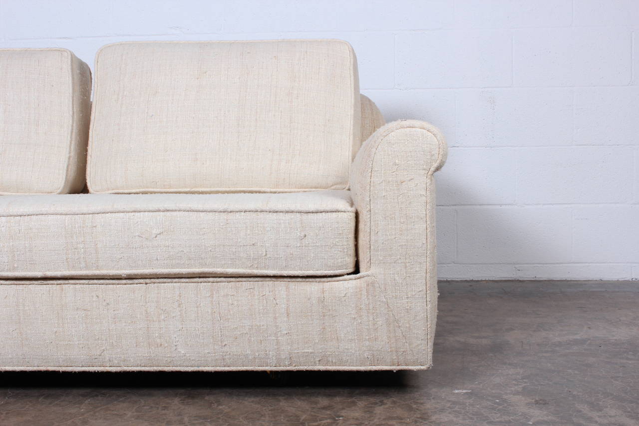 A matching pair of large-scale settees designed by Edward Wormley for Dunbar upholstered in raw silk.