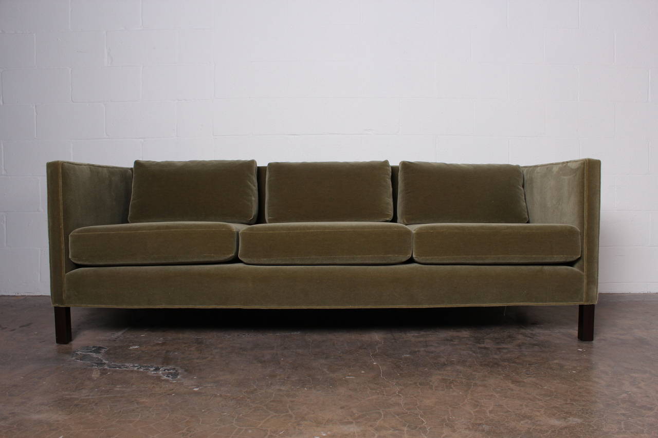 A Classic tuxedo form with walnut legs and down pillows. Designed by Edward Wormley for Dunbar. Fully restored with green mohair.