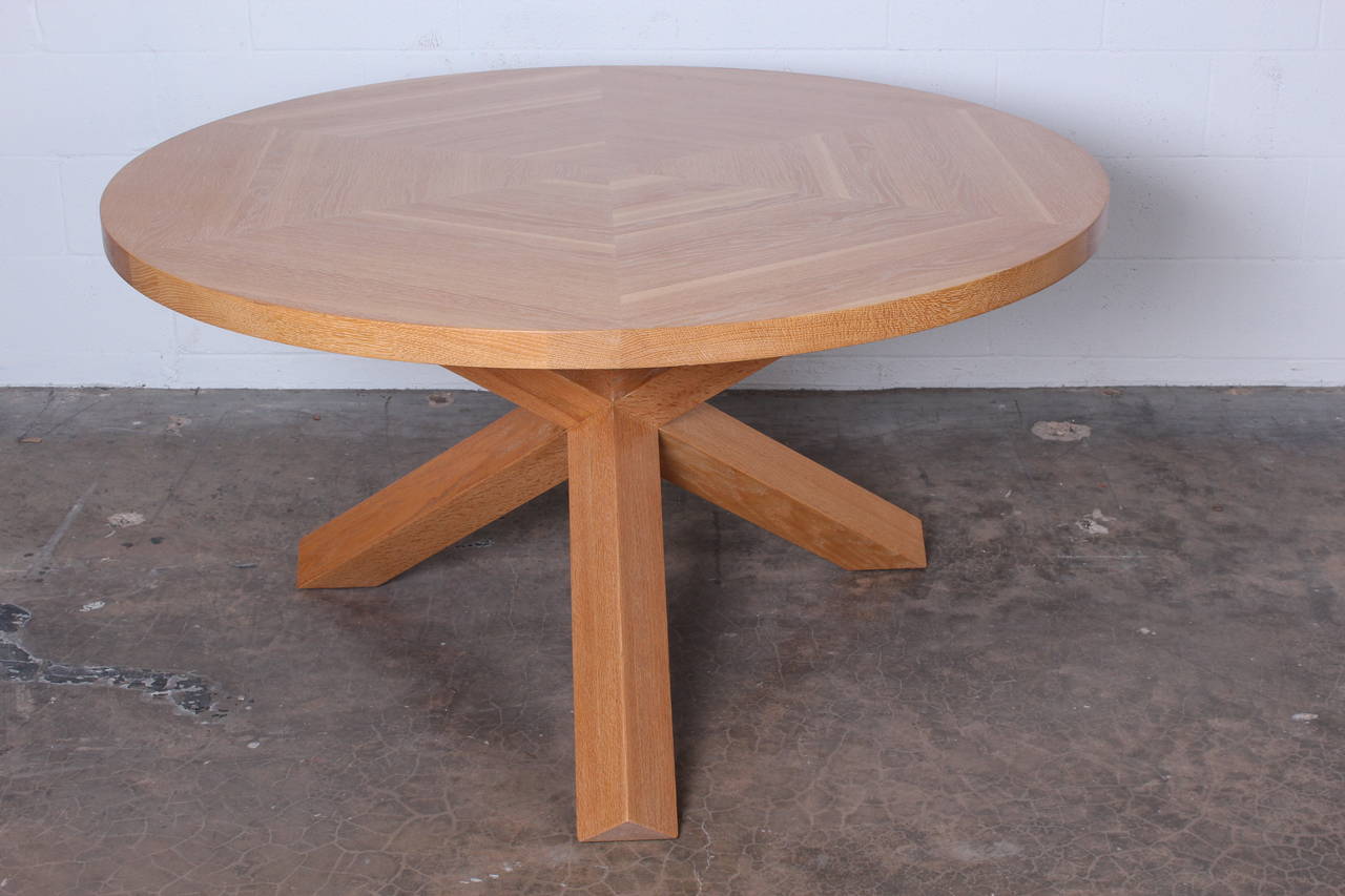 A solid oak La Rotonda dining table designed by Mario Bellini for Cassina.