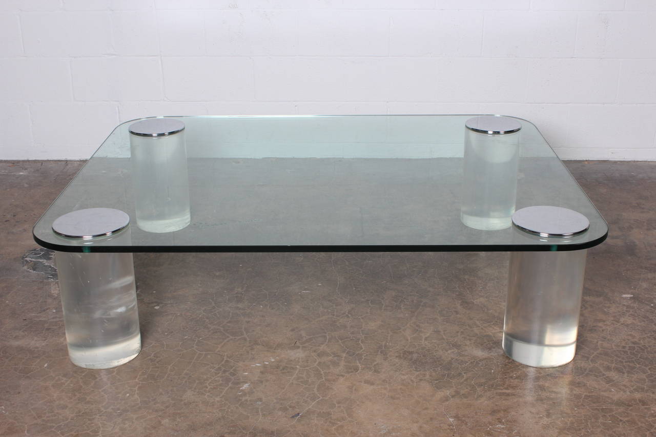 A large-scale glass coffee table with 8