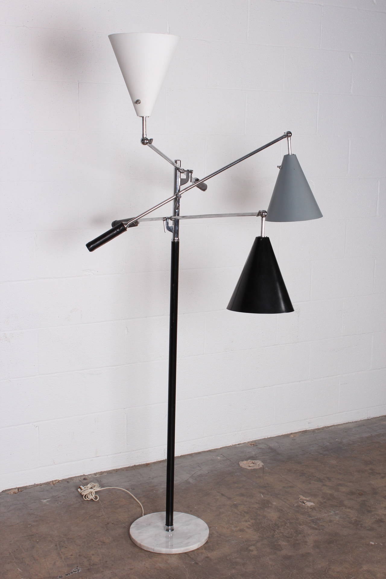 Iconic Triennale floor lamp by Arredoluce. This version with marble base and black leather handles.