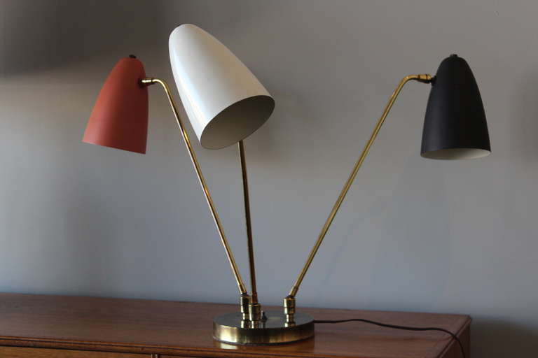A rare table lamp with pivoting arms and heads designed by Ben Seibel. This example is in all original condition.