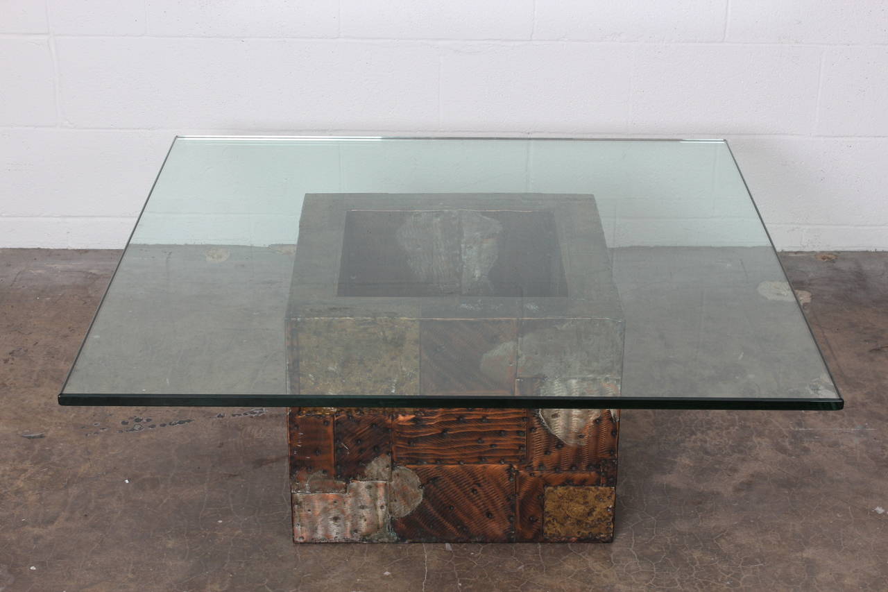 A patchwork metal table with glass top. Designed by Paul Evans for Directional.