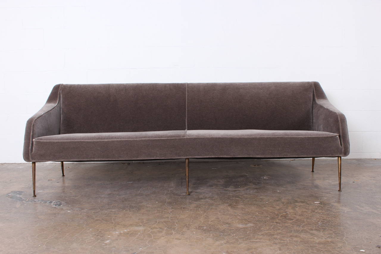 A rare sofa on brass legs designed by Carlo di Carli and manufactured by Cassina for Singer & Sons.