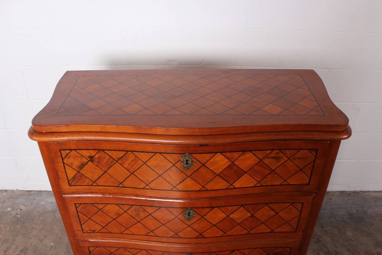 A turn of the century Swedish drop front desk with diamond parquetry and a bowed front.