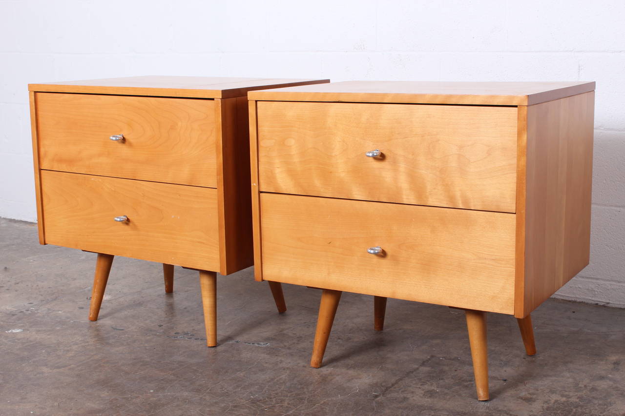 A pair of two-drawer maple nightstands designed by Paul McCobb for Winchendon.
