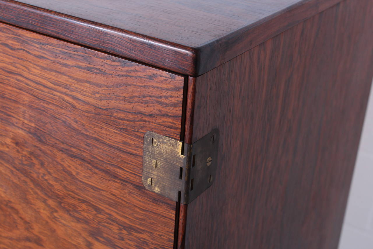 A beautifully grained and finely detailed rosewood dresser with removable trays. Designed by Svend Langekilde.