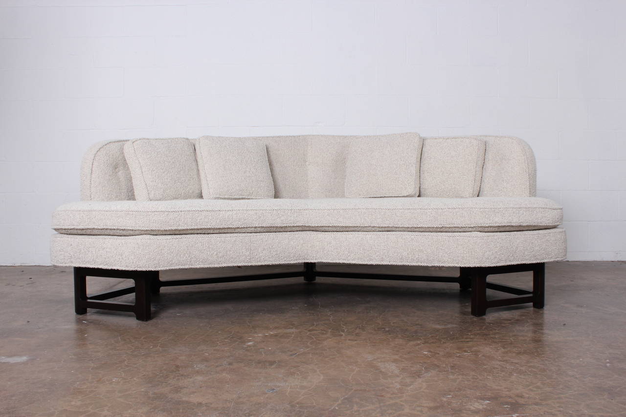 A beautifully detailed sofa with solid mahogany sculpted base. Designed by Edward Wormley for Dunbar. Fully restored and upholstered in Maharam pebble wool.