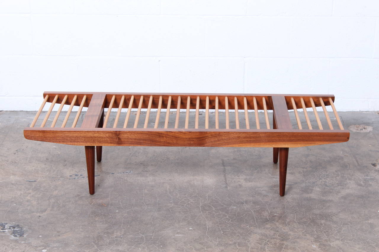 A walnut and maple bench designed by Milo Baughman for Glenn of California.
