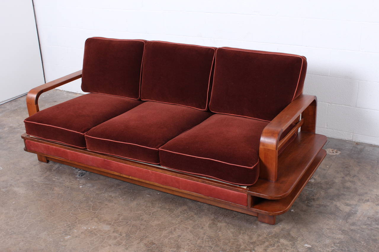 A rare sofa designed by Russel Wright for Conant Ball in 1935. An asymmetrical maple frame with mohair upholstery and leather trim.