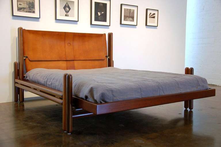 Rare and original 'Toledo' bed designed by Carlo Scarpa for Gavina in 1975.
The frame is made of turned poles of solid maple sandwiched between solid
rosewood.
Brass hardware and fittings.  Natural undyed leather headboard with
beautiful