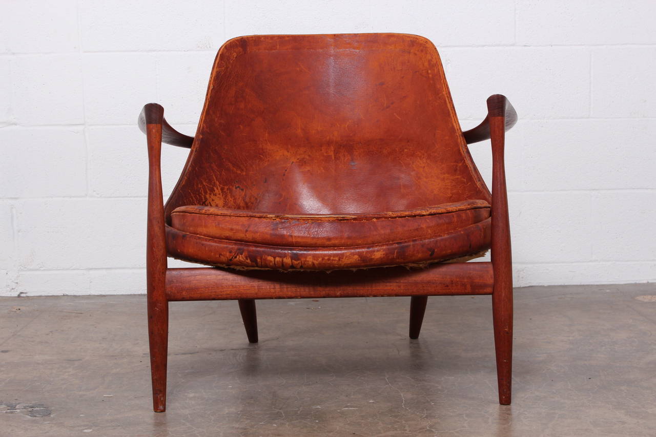 A teak Elizabeth chair with original leather and amazing patina. Designed by Ib Kofod-Larsen, 1956, executed and marked by cabinetmakers Christensen & Larsen, Denmark. Model U-56.

Original patinated teak and leather.