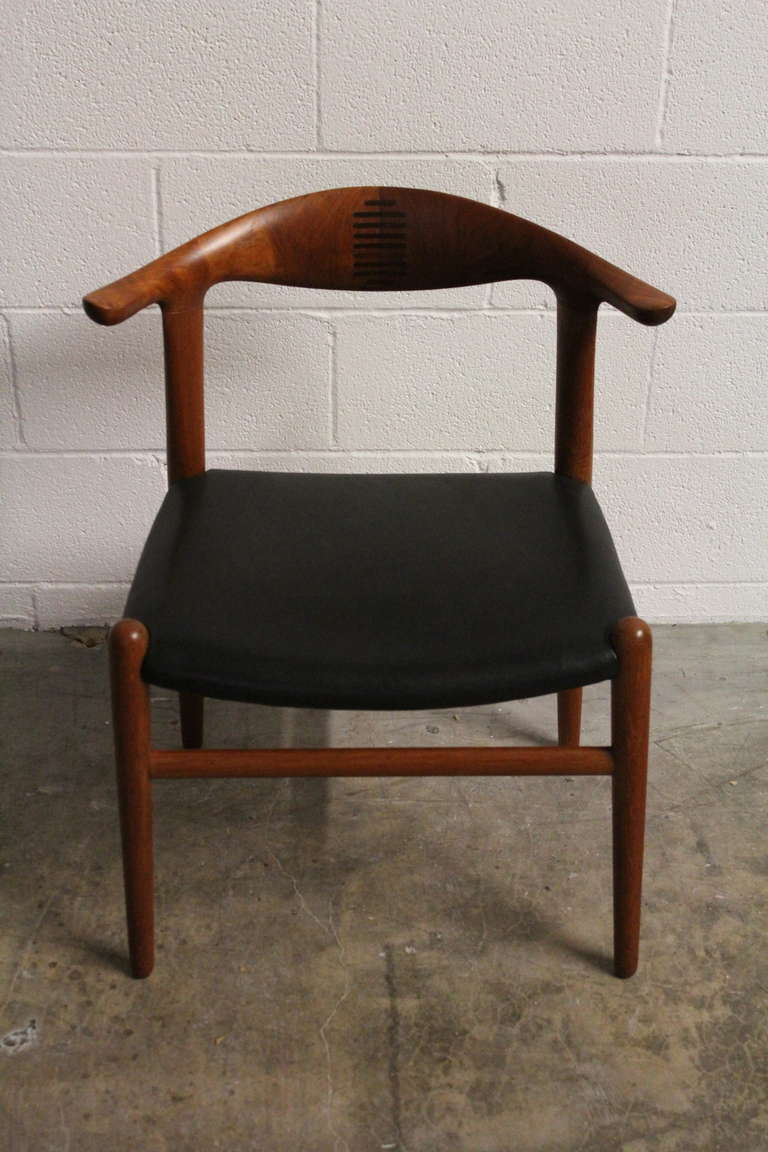 A teak cowhorn chair designed by Hans Wegner for Johannes Hansen.