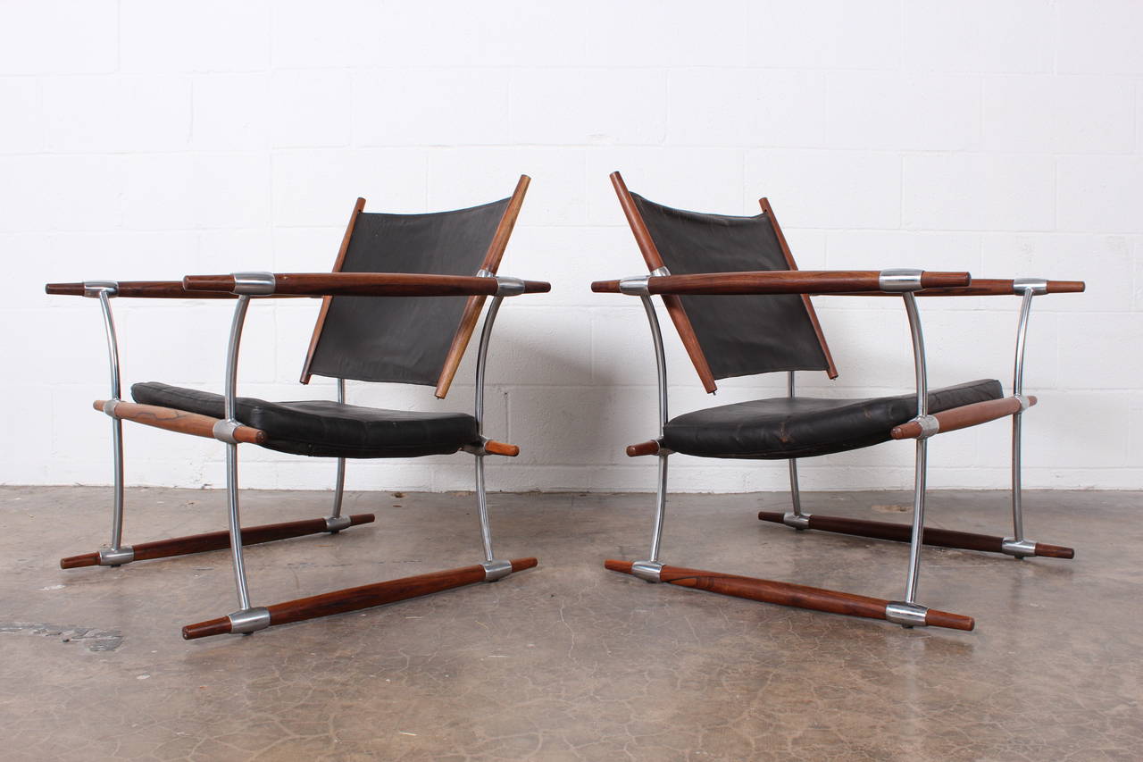 A pair of rosewood lounge chairs with original black leather. Designed by Jens Quistgaard for Nissen of Denmark.