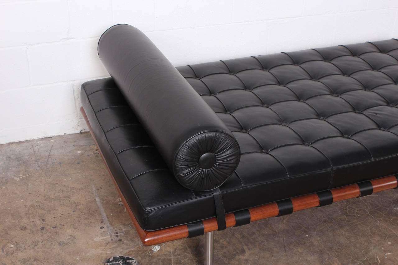 A black leather Barcelona daybed with walnut frame. Designed by Mies van der Rohe for Knoll.