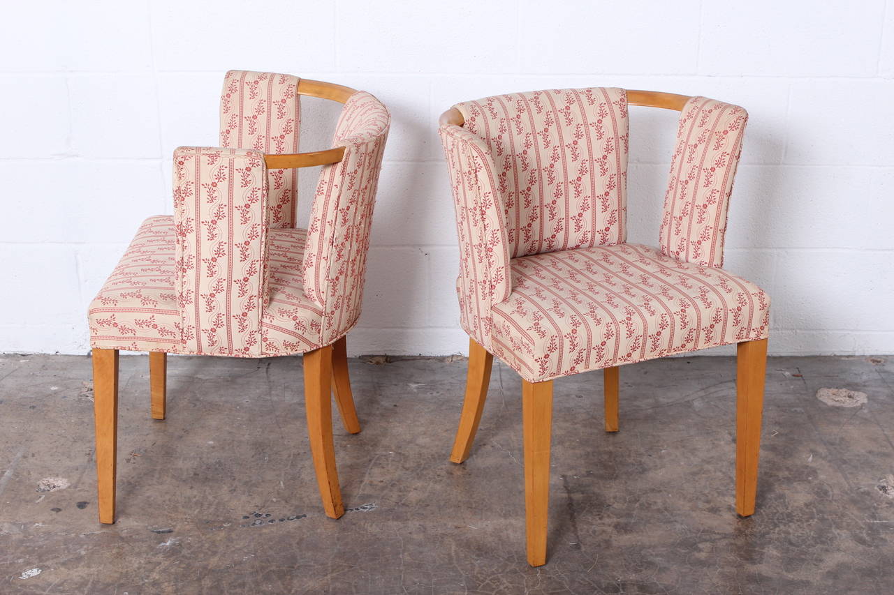 A set of eight armed dining chairs designed by Eliel Saarinen for Johnson Furniture.