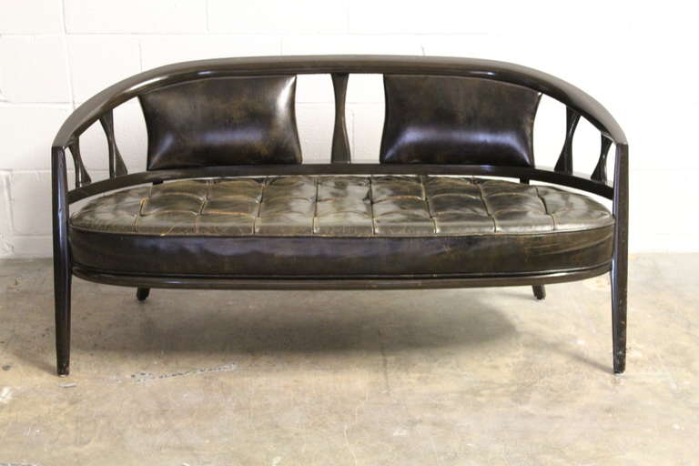 An elegant settee with original patinated leather upholstery. Designed by Maurice Bailey for Monteverdi-Young.