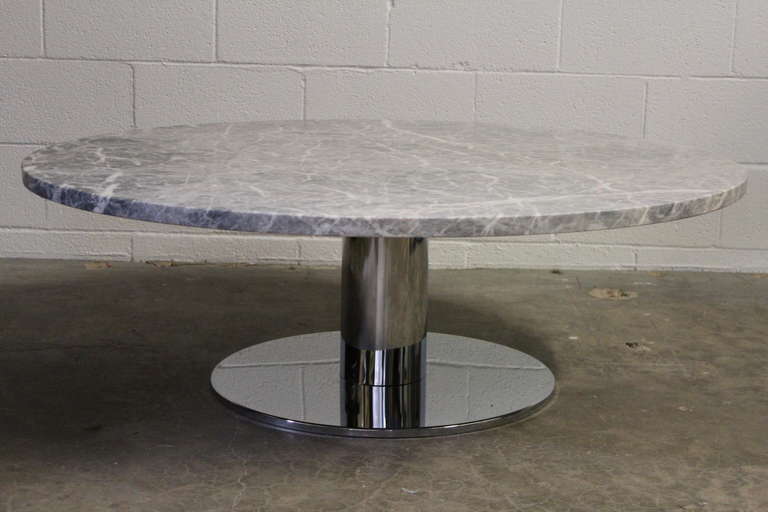 A chrome based coffee table with large honed marble top.