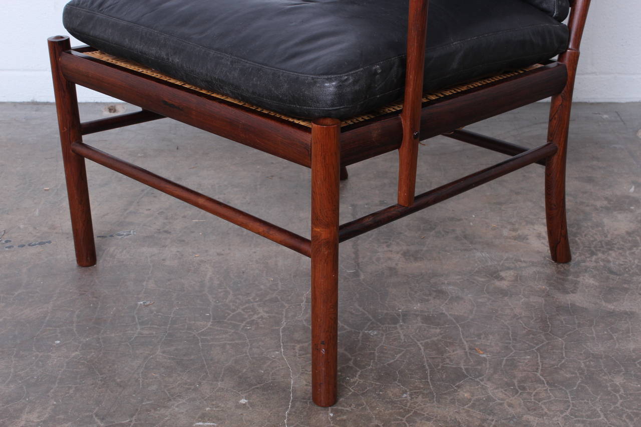 A beautiful rosewood and leather armchair designed by Ole Wanscher for
P. Jeppesen. Solid rosewood frame with original patinated black leather.