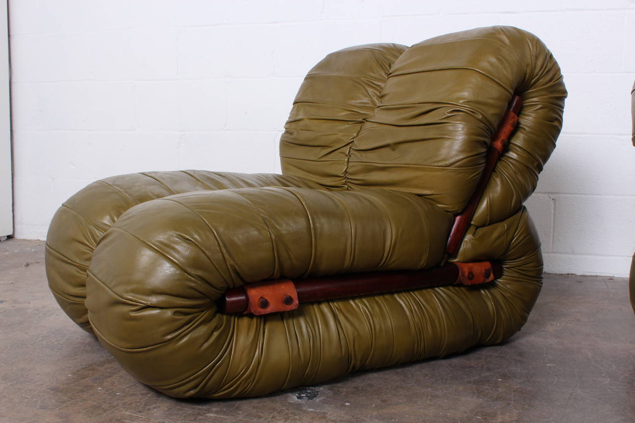 A rare and beautiful pair of green leather and rosewood lounge chairs designed by Percival Lafer.