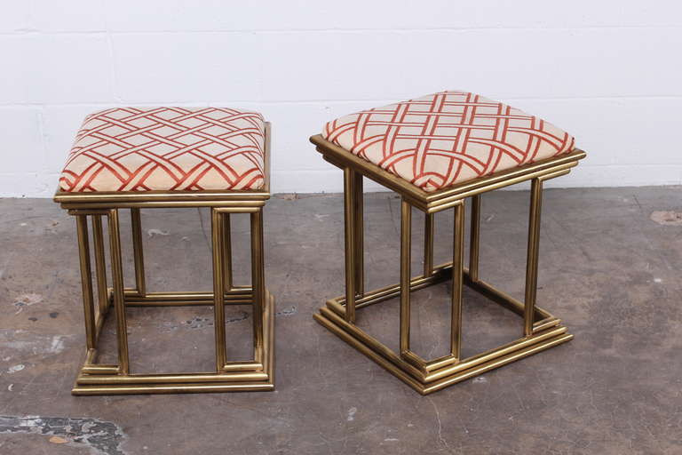 A pair of architectural brass stools marked made in Italy.