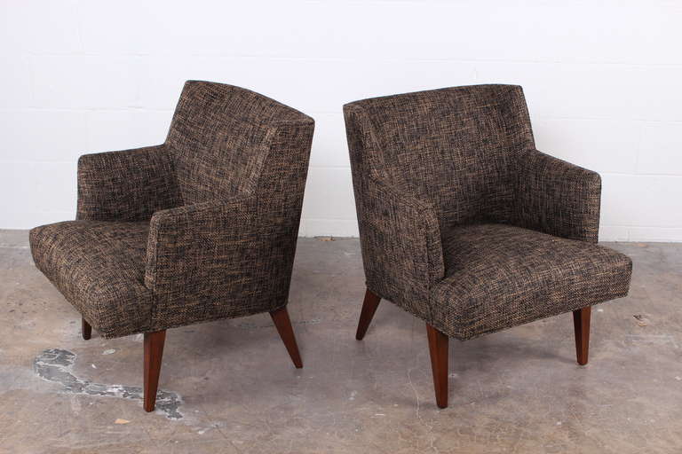 A pair of upholstered armchairs on mahogany legs. Designed by Edward Wormley for Dunbar.