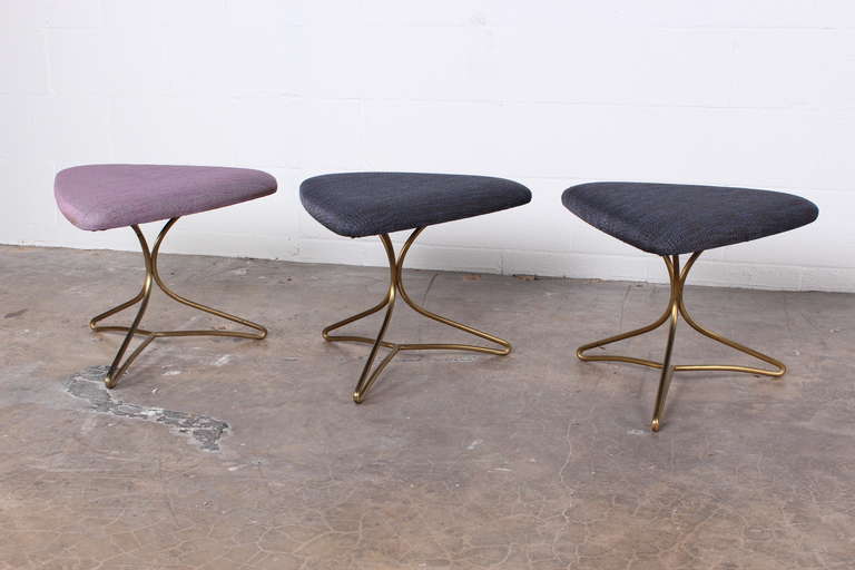 A set of three stools with solid brass bases. Designed by Vladimir Kagan.