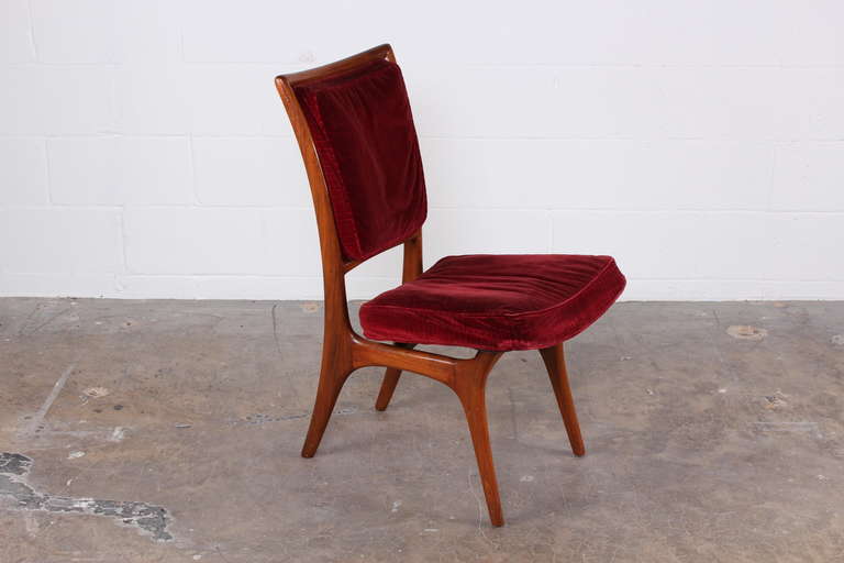 A sculptural walnut desk chair designed by Vladimir Kagan.