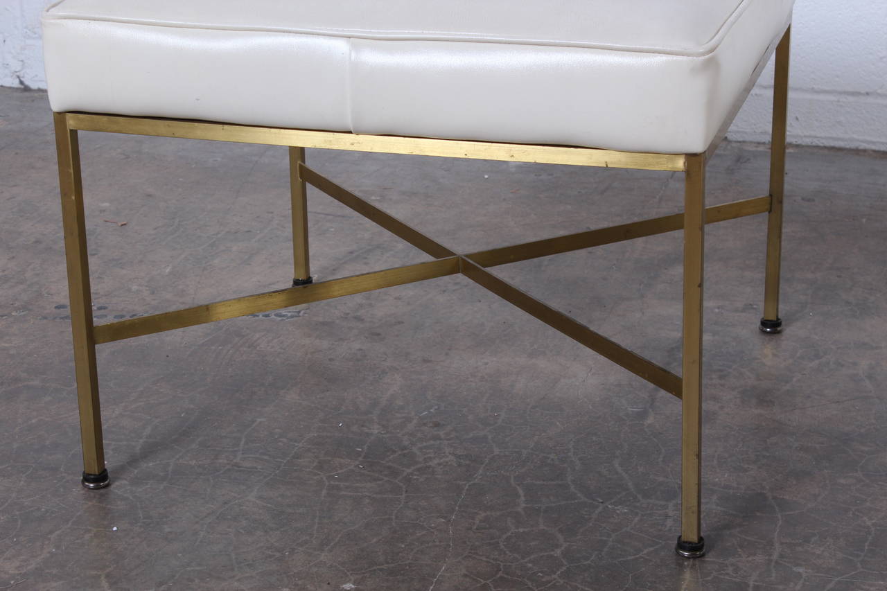 A pair of brass stools with original vinyl upholstery. Designed by Paul McCobb for Calvin.