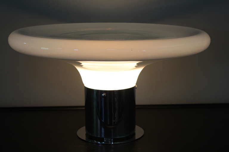 A sculptural table lamp with white glass shade that fades to clear in the center.