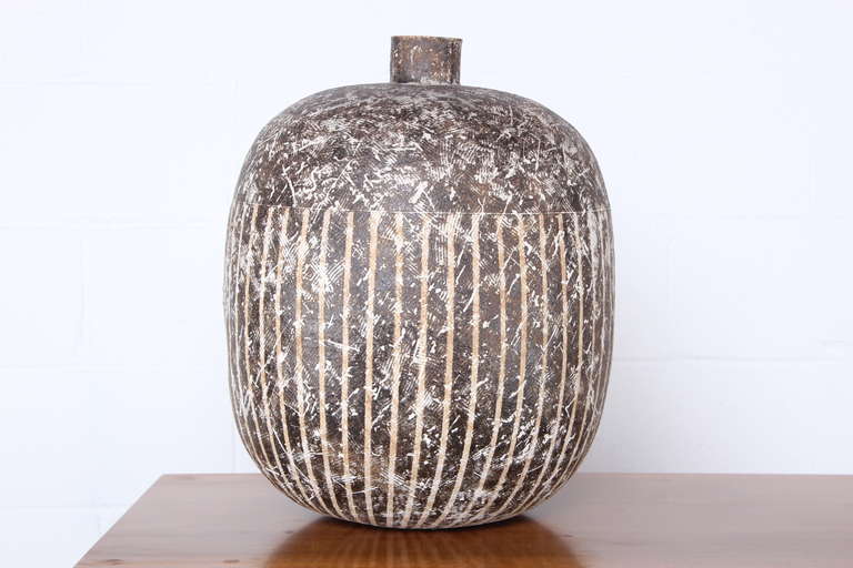 A large striped vessel by Cleveland, Ohio ceramicist Claude Conover.