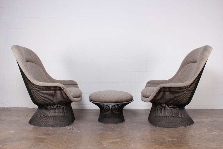 A nice early pair of solid bronze throne chairs and ottoman designed by Warren Platner for Knoll. This set has been completely restored in Maharam Wool fabric.