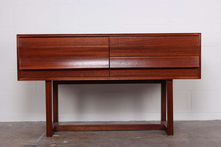 A three drawer mahogany console table designed by Paul Laszlo for Brown Saltman.