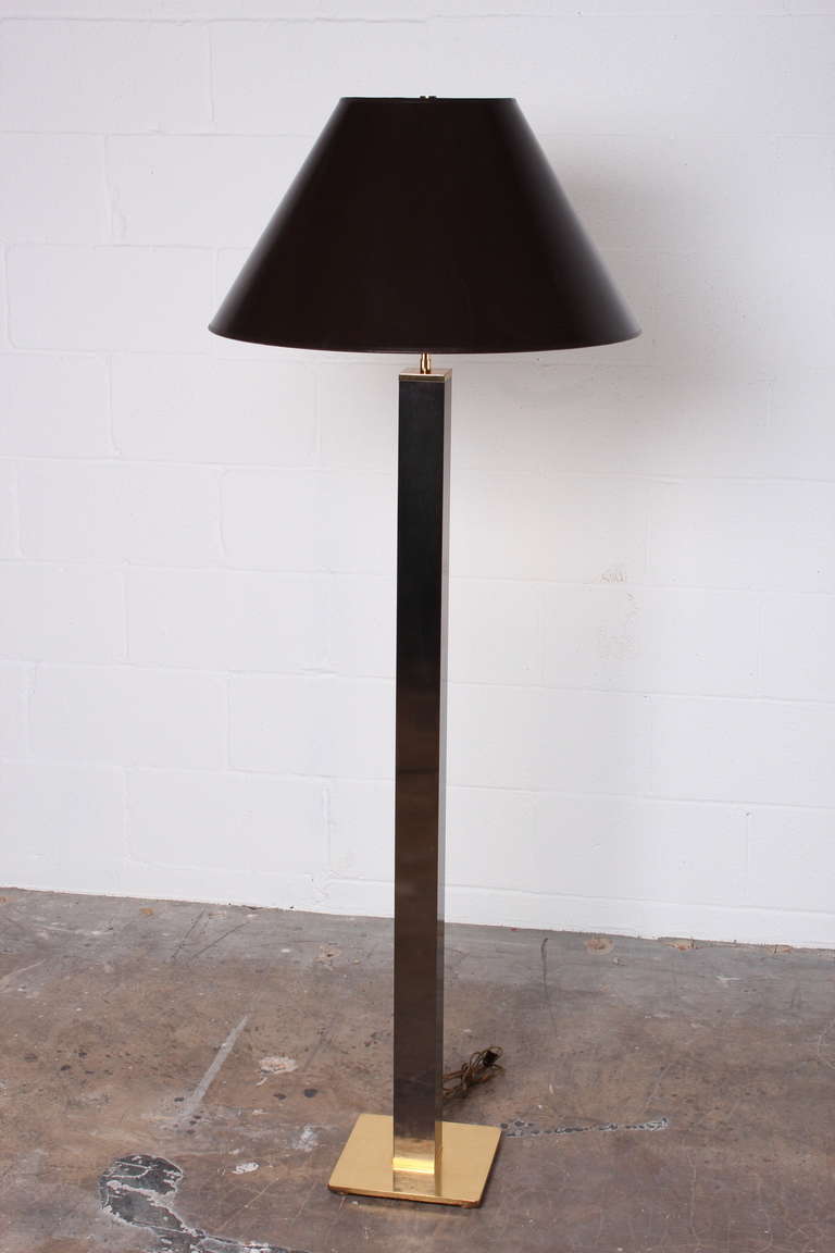 A gunmetal and brass floor lamp with original parchment shade. Designed by Karl Springer.