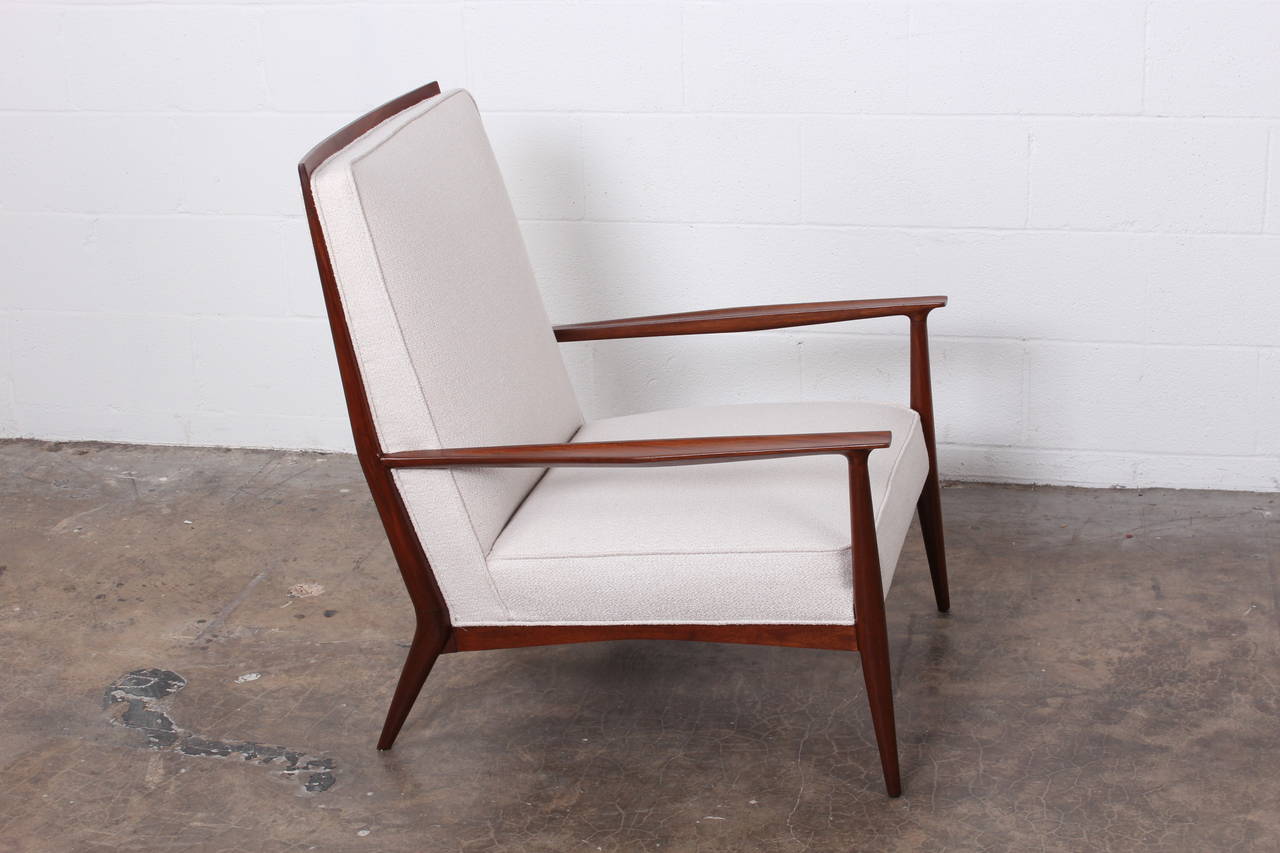 A walnut framed lounge chair designed by Paul McCobb. Fully restored.
