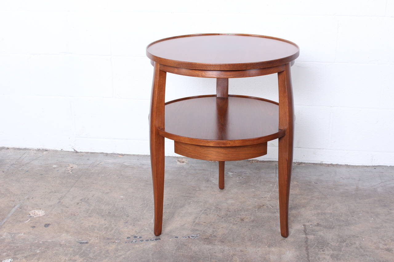 A beautiful walnut side table with sculptural legs and a single drawer. Designed by Edward Wormley for Dunbar.