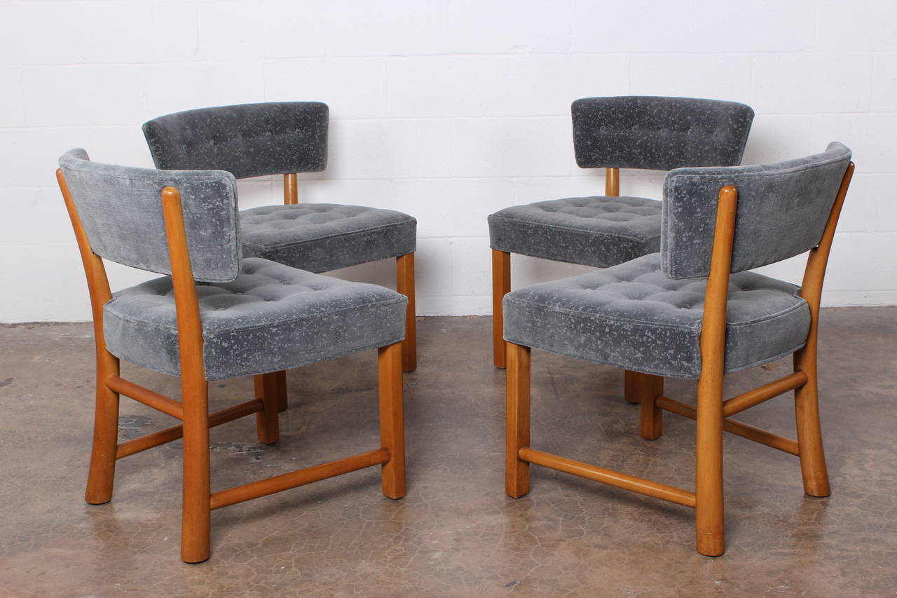 A set of four dining chairs with bleached mahogany frames. Designed by Edward Wormley for Dunbar.