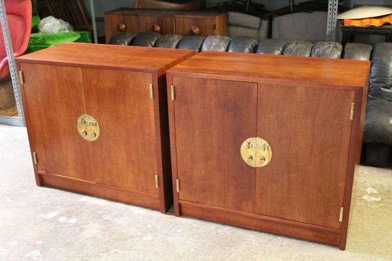 A matching pair of cabinets with adjustable shelves and brass hardware. Designed by Edward Wormley for Dunbar.