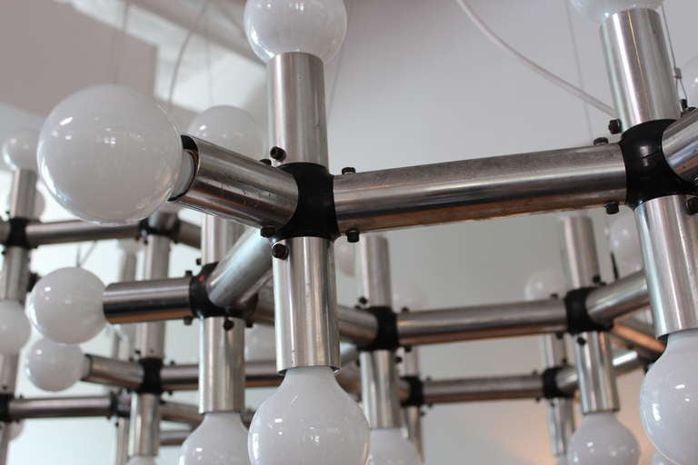 A massive two tier molecule light fixture with 56 bulbs. Designed by Robert Haussmann for Swiss Lamp International. Fixture has three power sources and hangs from five wires.
