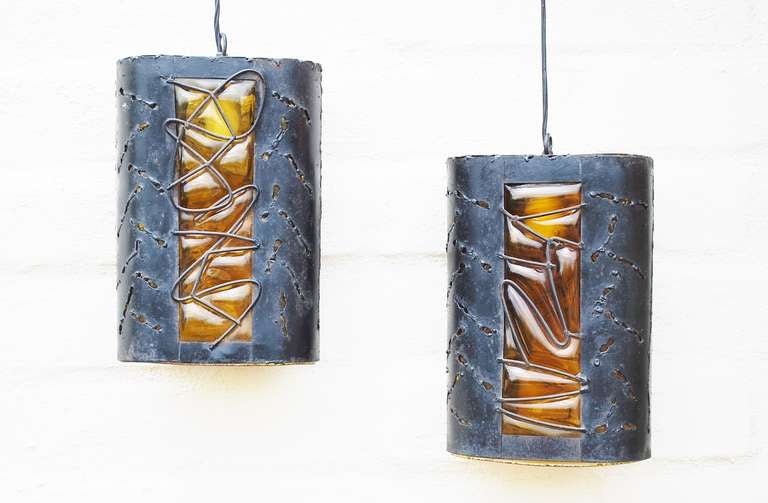 A pair of studio made brutalist sconces with torch cut metal and amber blown glass. Can be used with wall mount brackets as sconces or without as pendent lights.