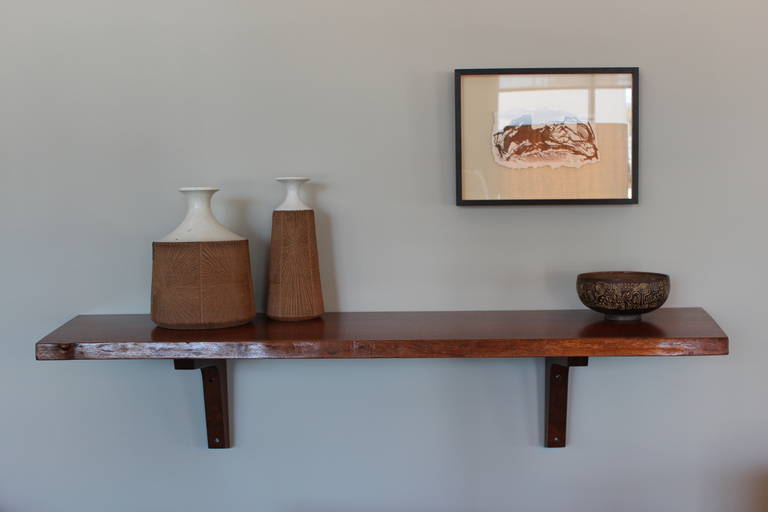 A free edge walnut wall shelf by George Nakashima. Four shelves available. Priced and sold individually, with original invoice.