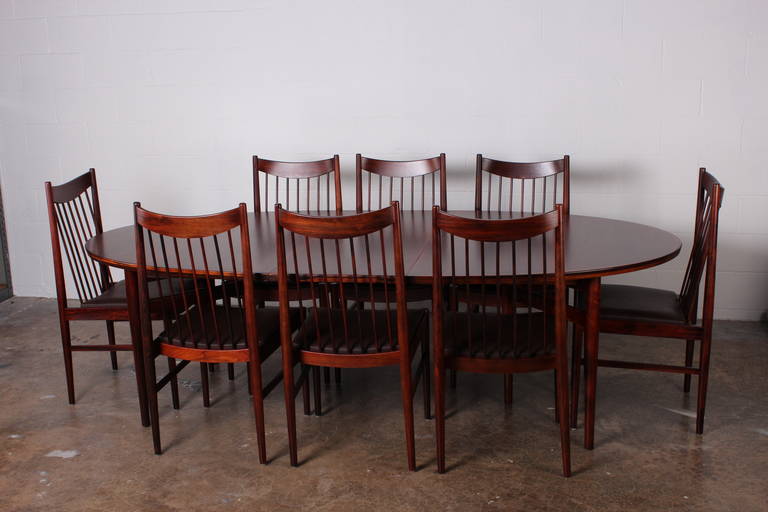 An oval rosewood six-legged dining table with leaf. Designed by Arne Vodder for Sibast Møbler. Chairs available is separate listing.