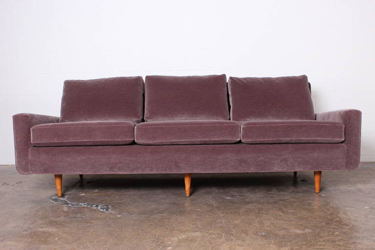 An early sofa design by Florence Knoll for Knoll with maple legs, mohair upholstery and down cushions.